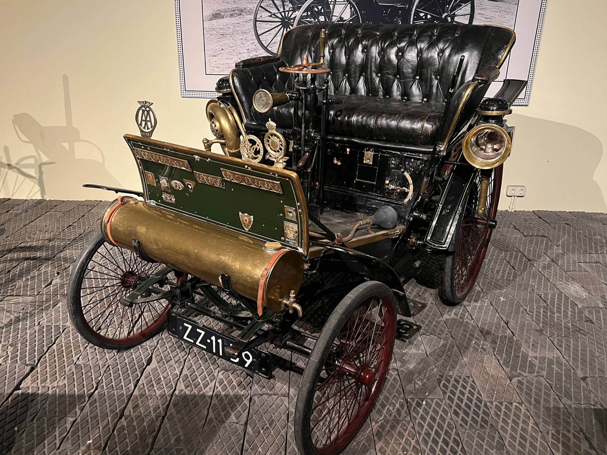 Early Benz-era International Benz on display at the Louwman Museum, featuring brass hardware, leather seating and a period control layout