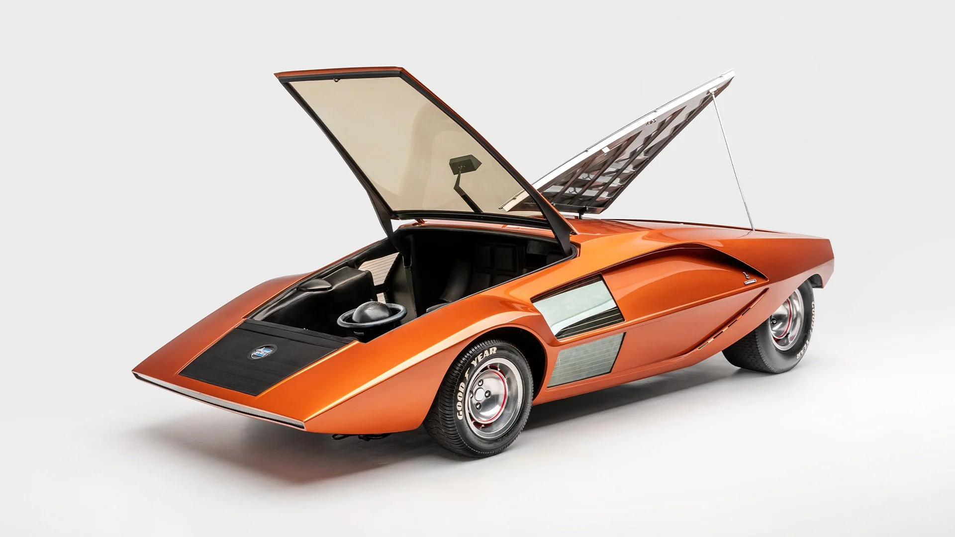 Lancia Stratos HF Zero front three-quarter view with canopy doors open in metallic orange (Credit: Petersen Museum)