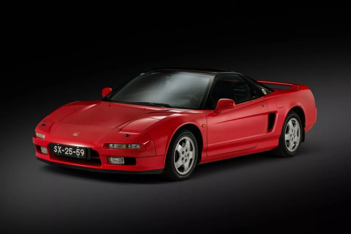 Honda NSX first generation sports car, side profile showing iconic wedge design.