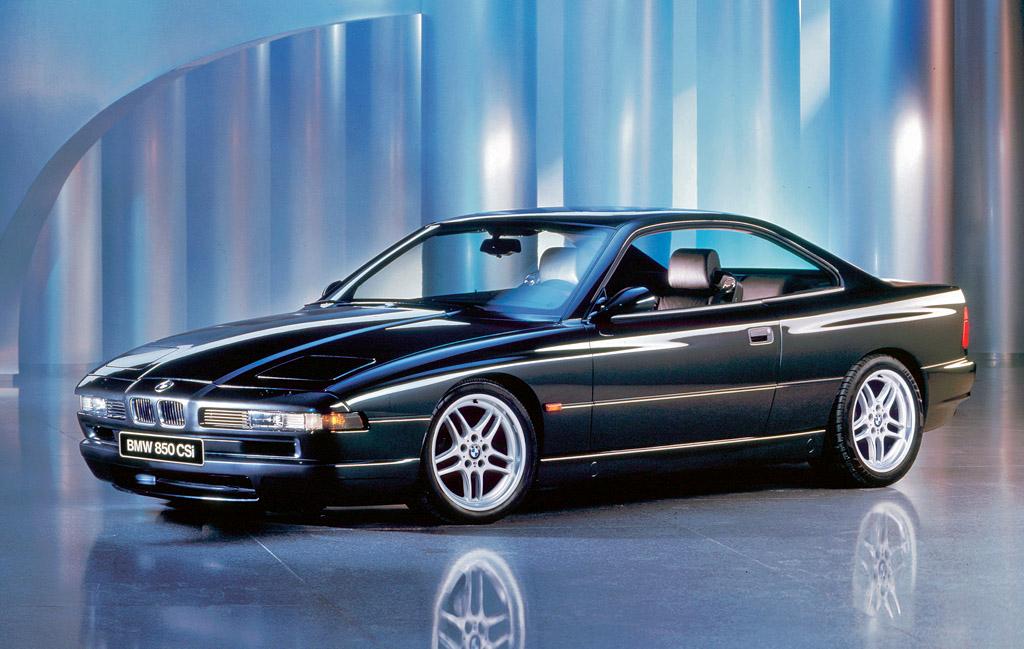 BMW E31 8 Series coupe with pop-up headlights, front three-quarter view.