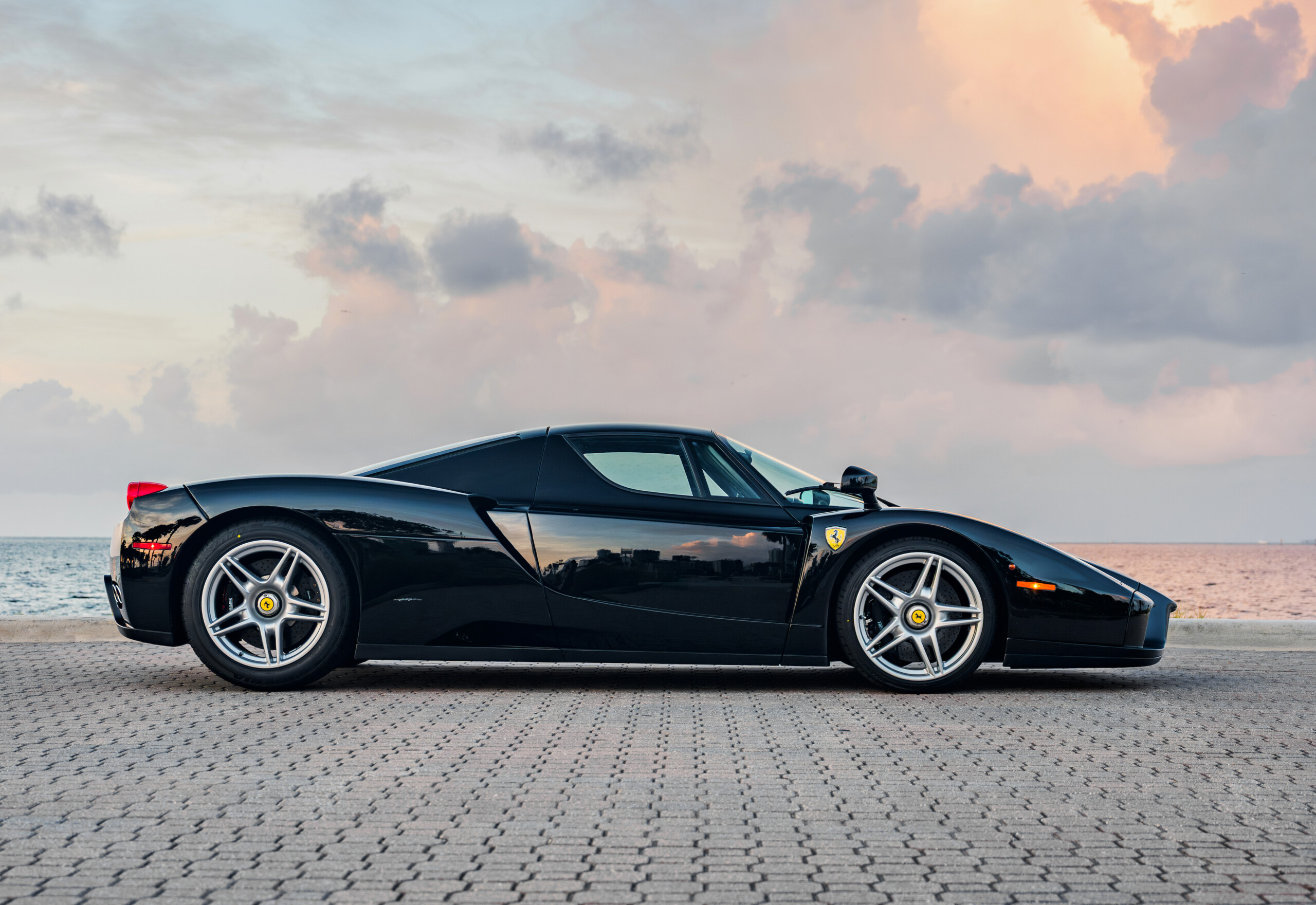 2003 Ferrari Enzo in Nero D.S., side profile at sunset.